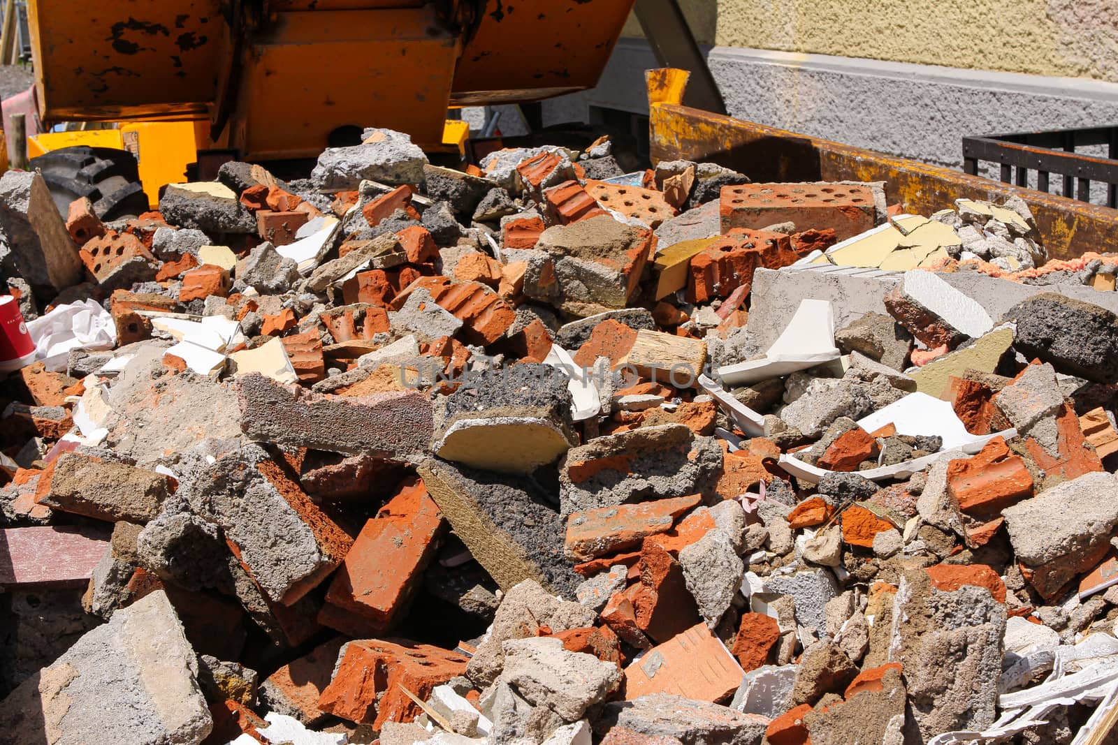 disposed red bricks piled up on junkyard. Brick rubble