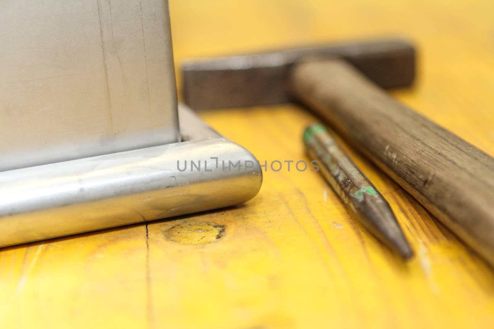 hammer and chisel tools for plumbers. With yellow background