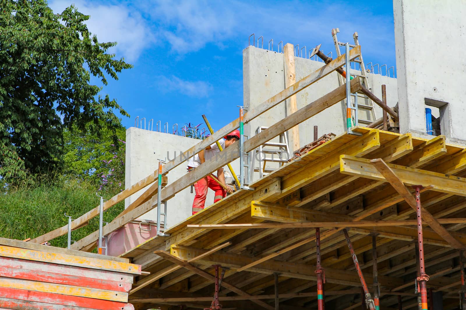 Hard working people at construction site with blue sky