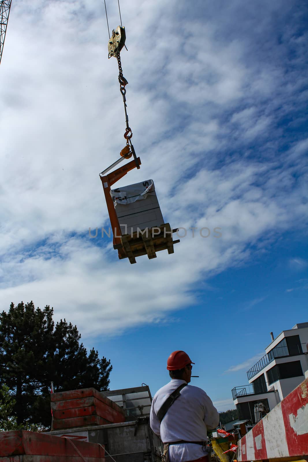 Hard working people at construction site. with blue sky