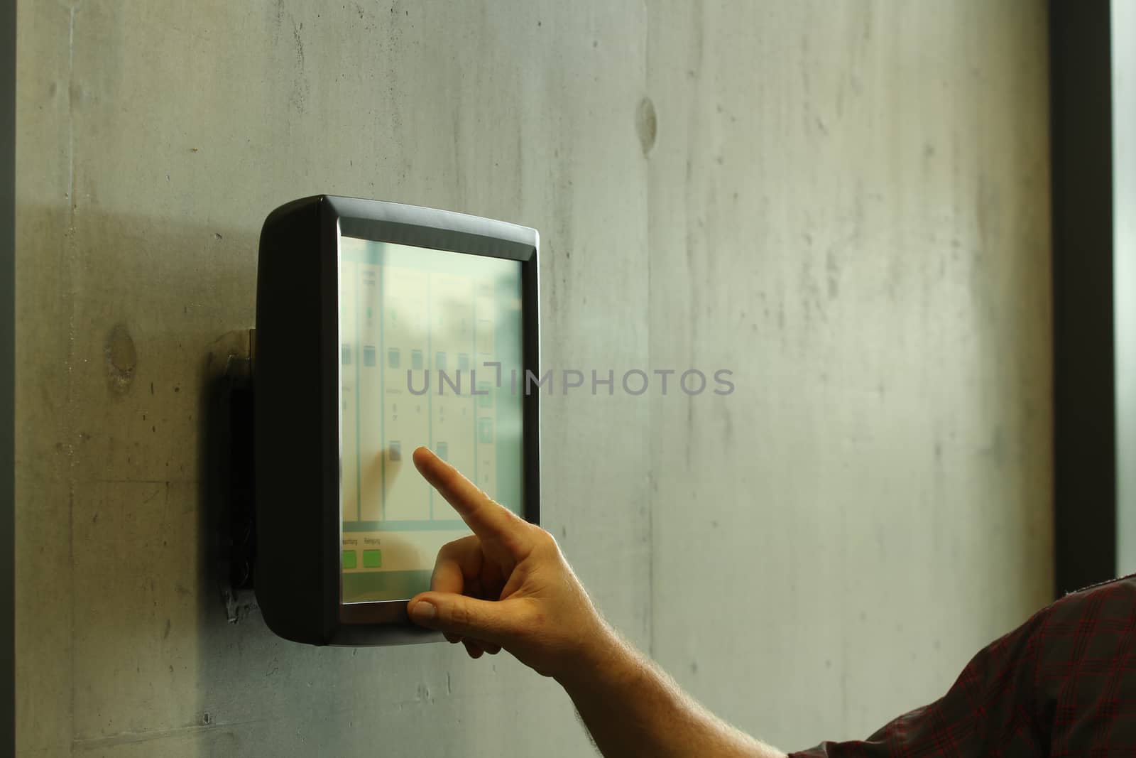 hand and arm controlling a room with a computer pad. with finger pointing