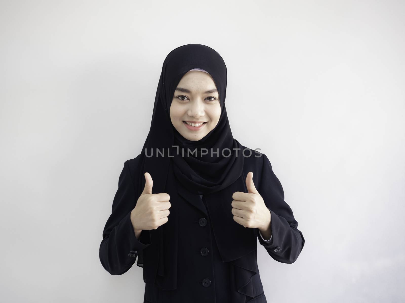 Isolated with clipping path. Smart beautiful Asian Muslim woman in modern kurung and hijab. Positive human emotion facial expression body language.