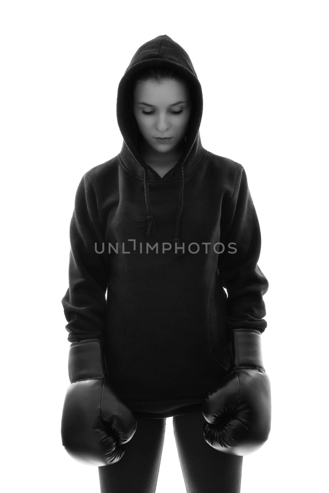 Focused young female boxer with hoodie and boxing gloves by Mendelex