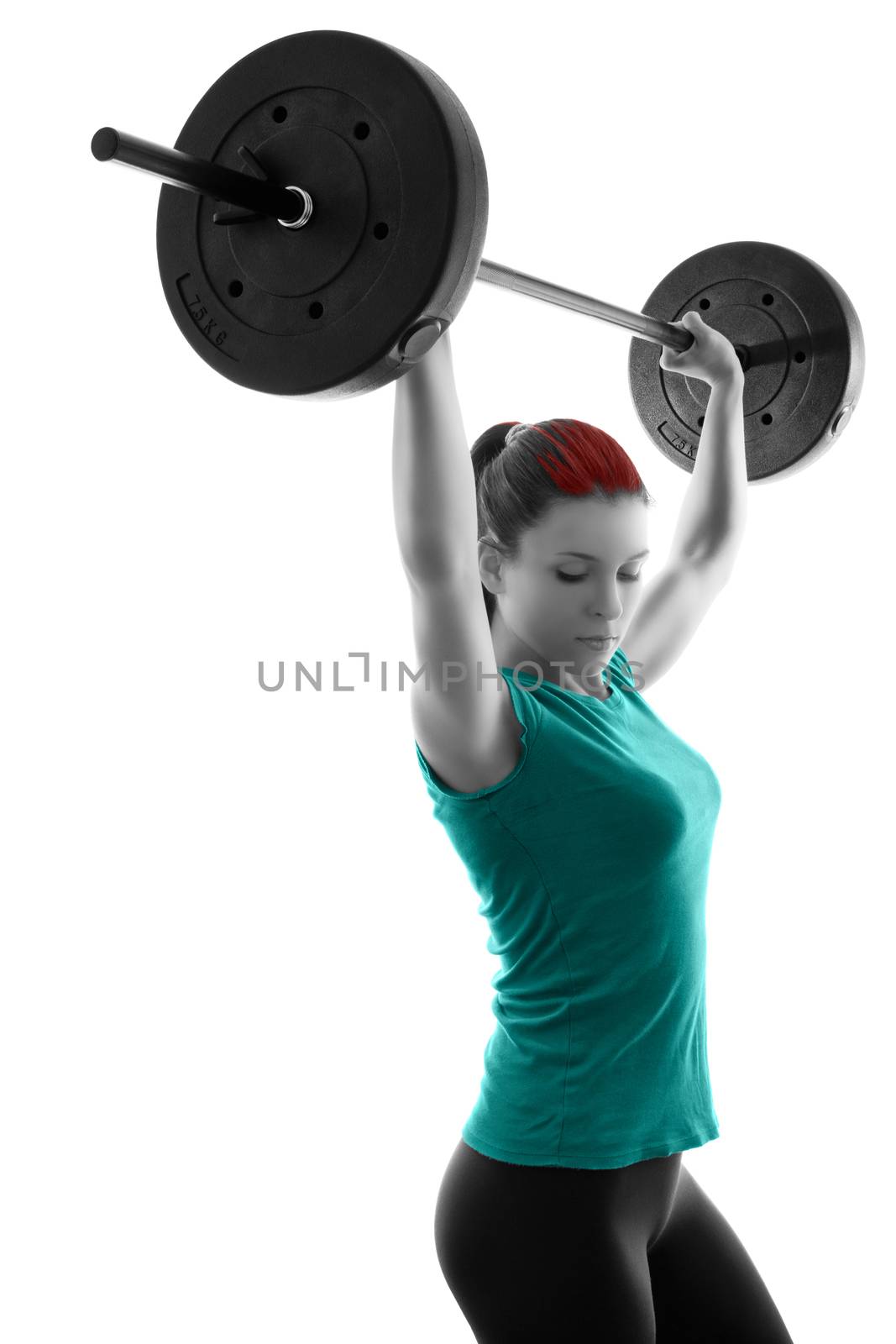 Fit attractive young woman working out with a barbell, doing shoulder press, backlit silhouette studio shot isolated on white background. Fitness and healthy lifestyle concept.
