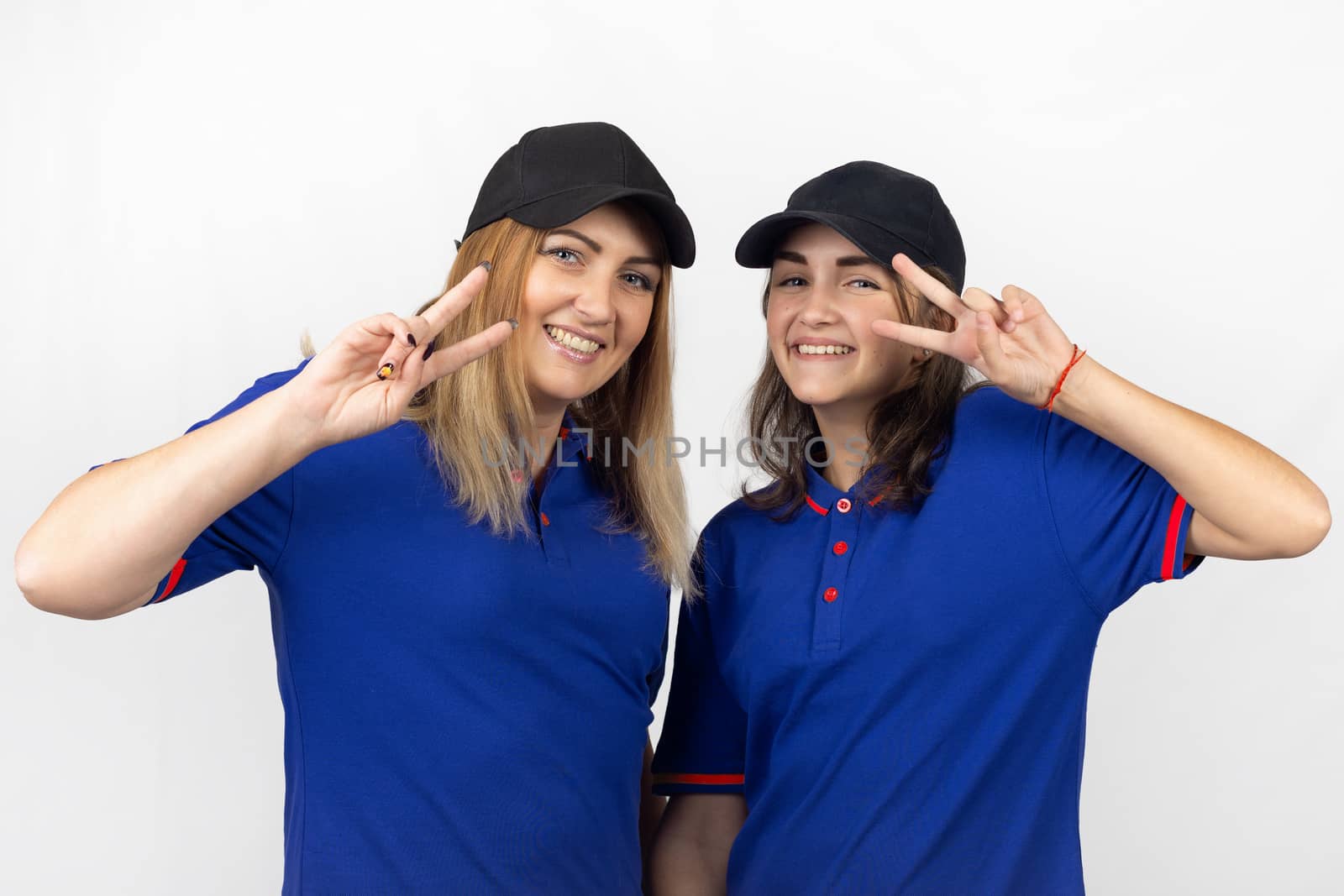 Portrait of two different-aged girls, in the same clothes