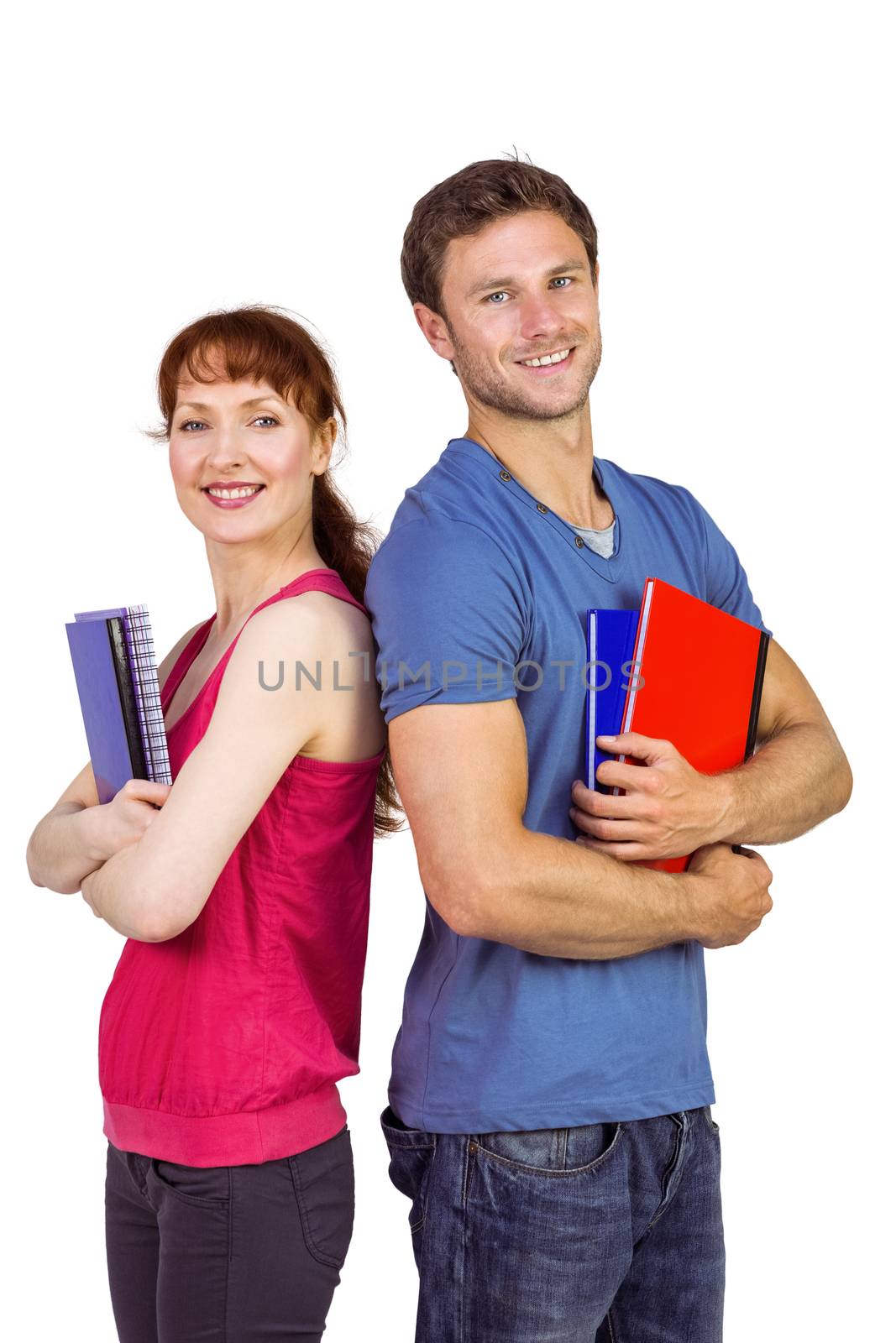 Two students both with notepads looking at camera