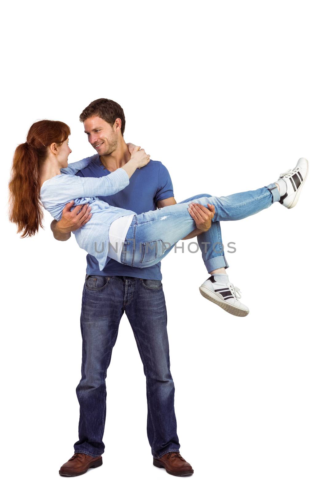 Man lifting up his girlfriend on white background