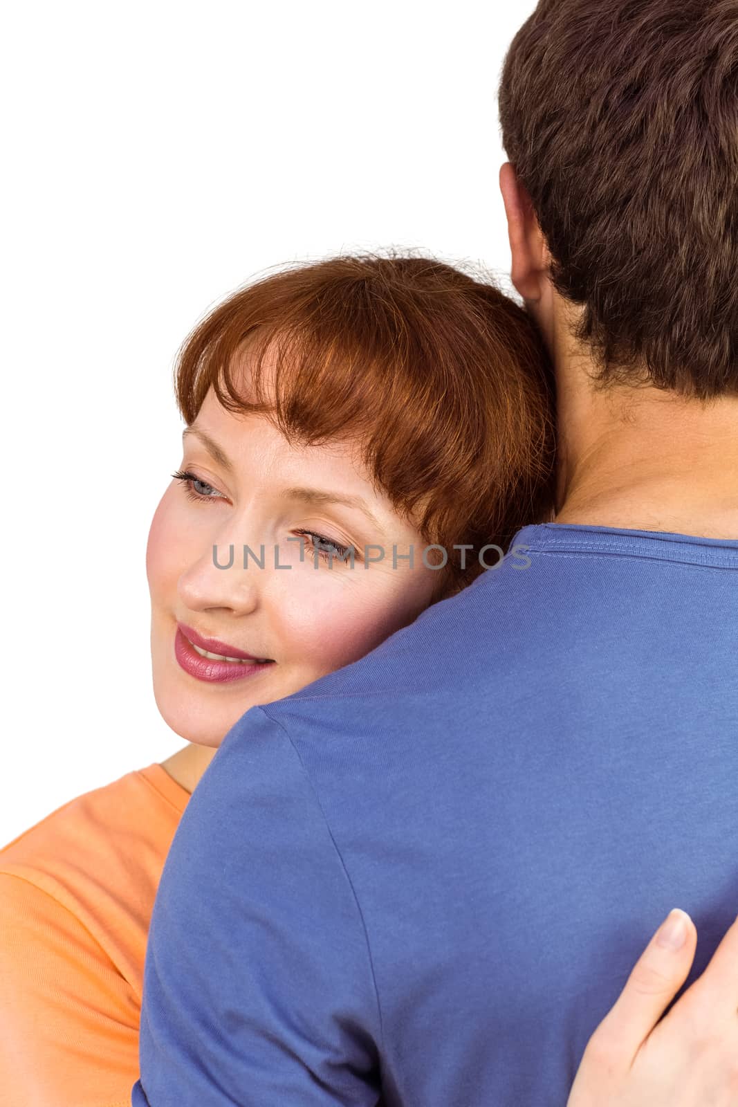 Happy couple hugging one another on white background