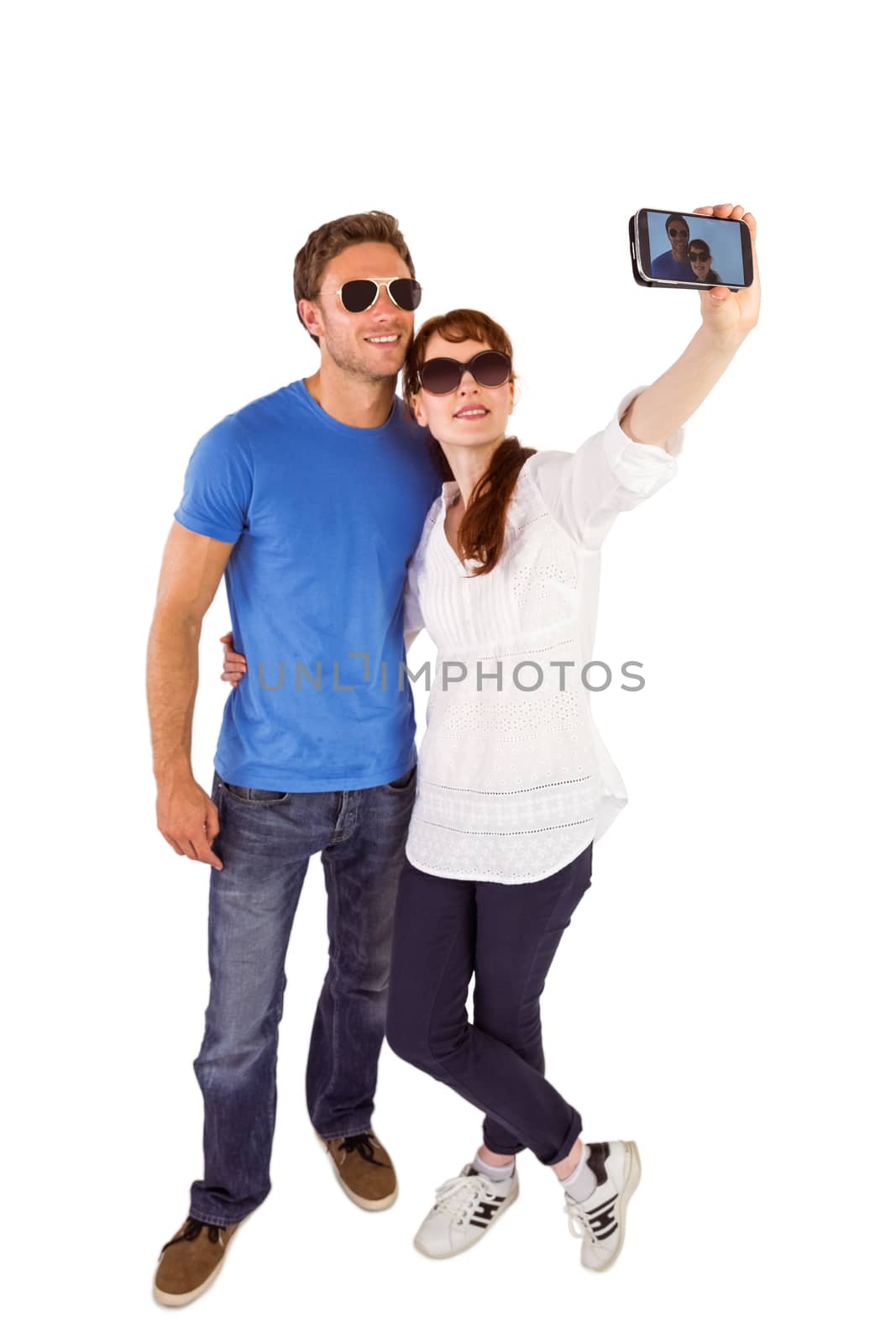 Couple using camera for picture on white background
