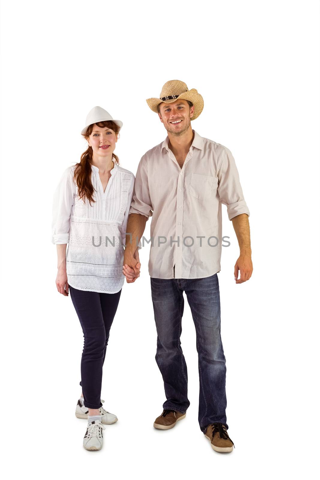 Smiling couple both wearing hats on white background