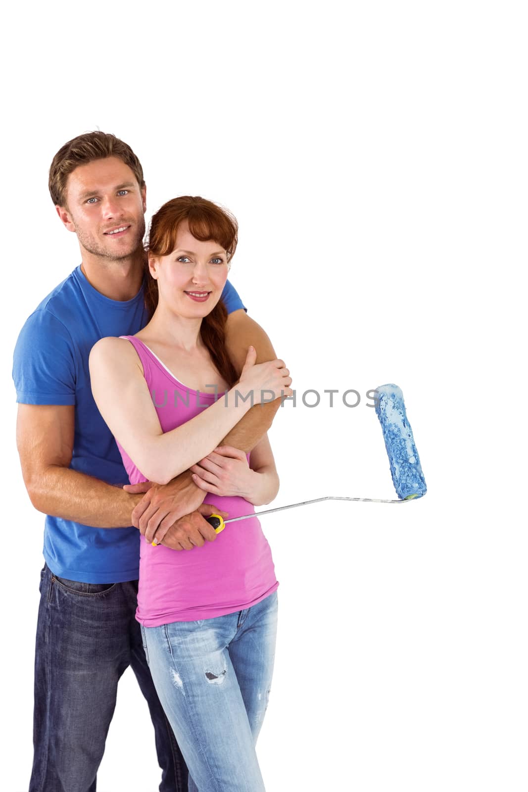Couple hugging and holding brush on white background