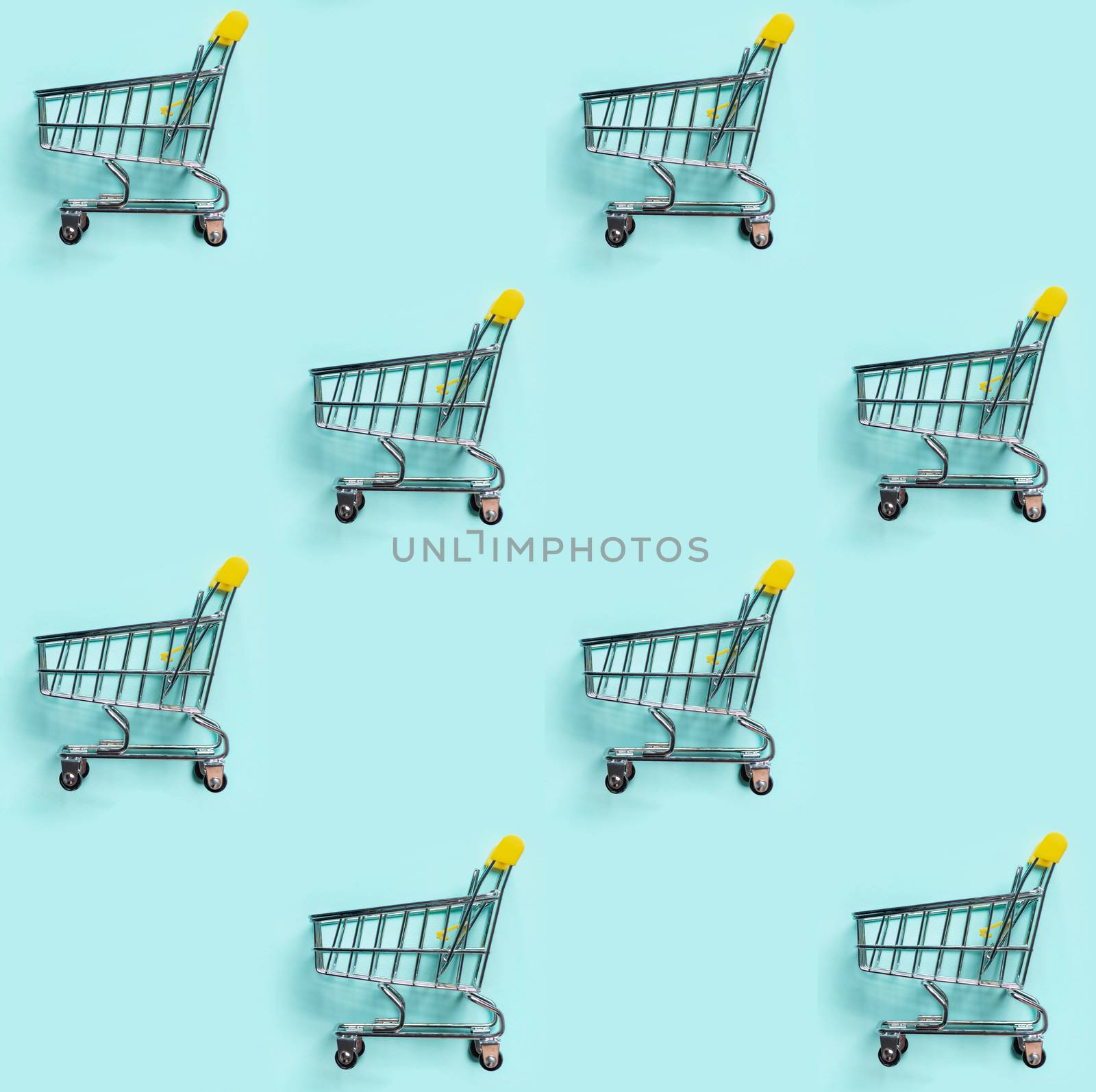 Shopping cart staggered on blue. Seamless pattern by fascinadora