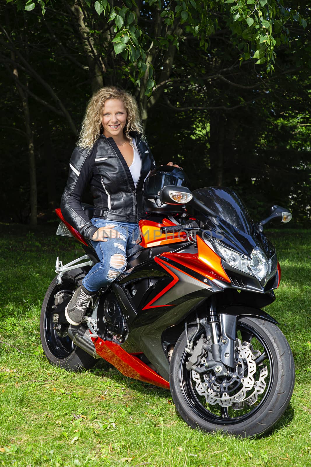 young blond woman, sitting on a sport motocycle