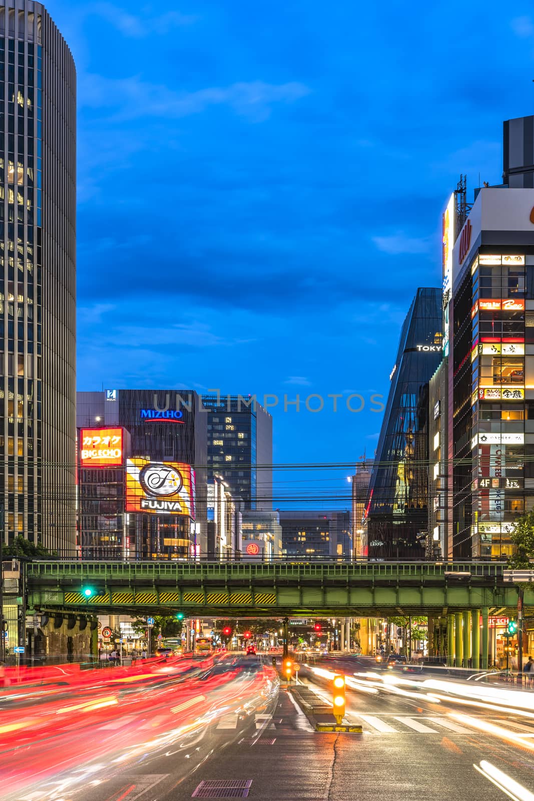 Night view of the Harumi street leading to Ginza district near to the entrance of the Hibiya Park (日比谷公園 Hibiya Kōen) in Chiyoda City of Tokyo in Japan. Harumi street is leading from the Iwaida Bridge intersection in Chiyoda Ward to the Shinonome intersection in Koto ward.