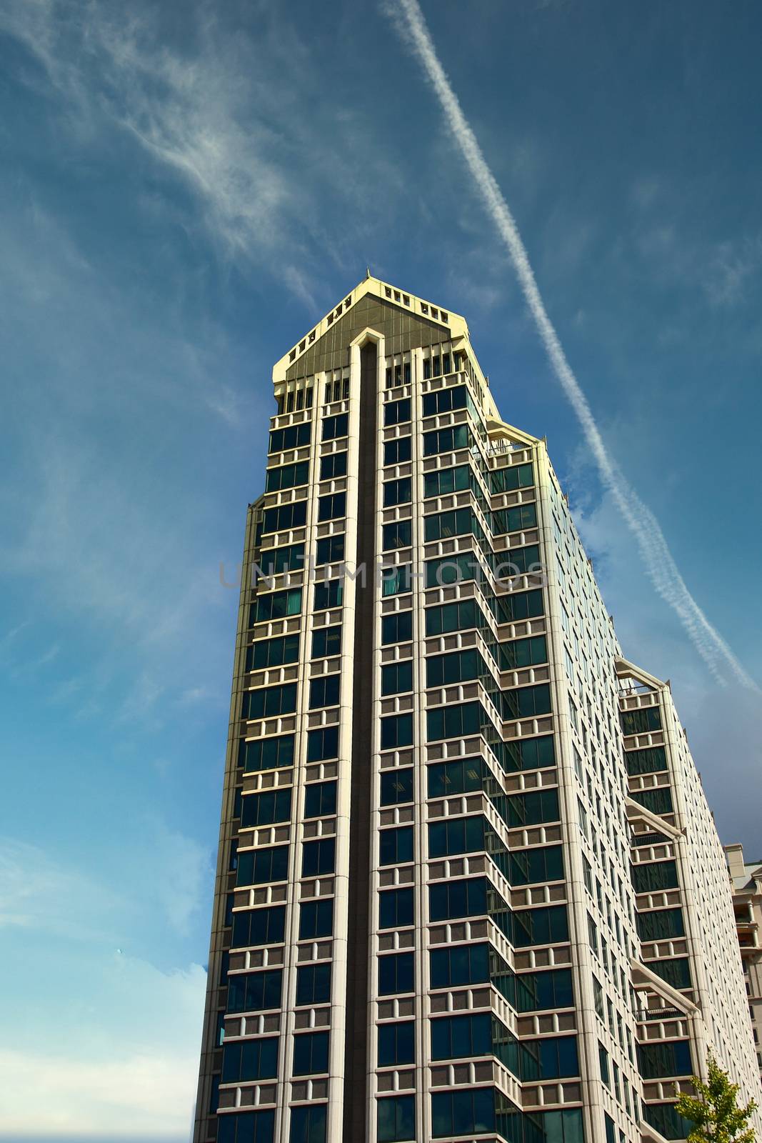 A modern high rise condominium building under nice blue skies