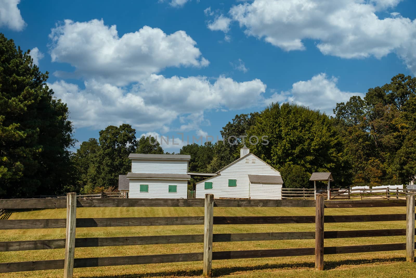 Old Barns with Green Shutters Past Fence by dbvirago