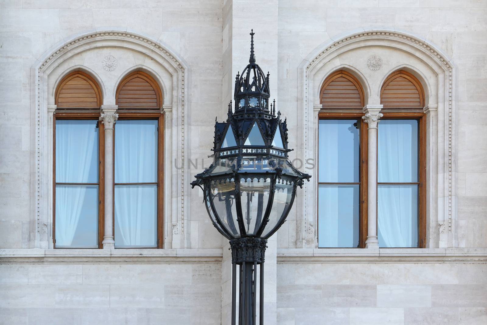 Street lamp in front of two windows of Parliament in Budapest, Hungary.