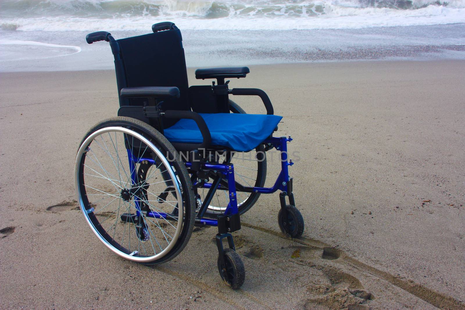 wheelchair left alone on a beach by the sea by alessiapenny90