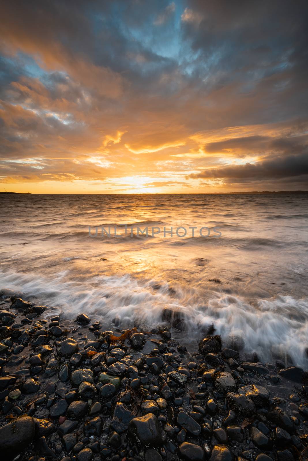 Dawn on Belfast Lough, viewed from Downshire beach, Carrickfergus, County Antrim, Northern Ireland.