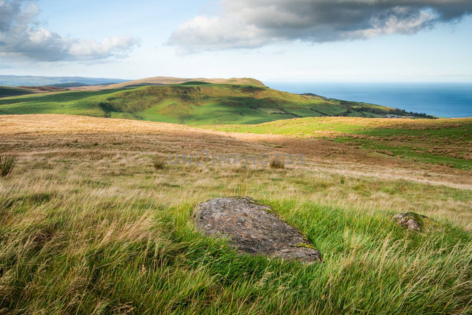 Light and shadows map the rolling hills of Antrim close to Ballygally on the North Antrim Coast, Northern Ireland.