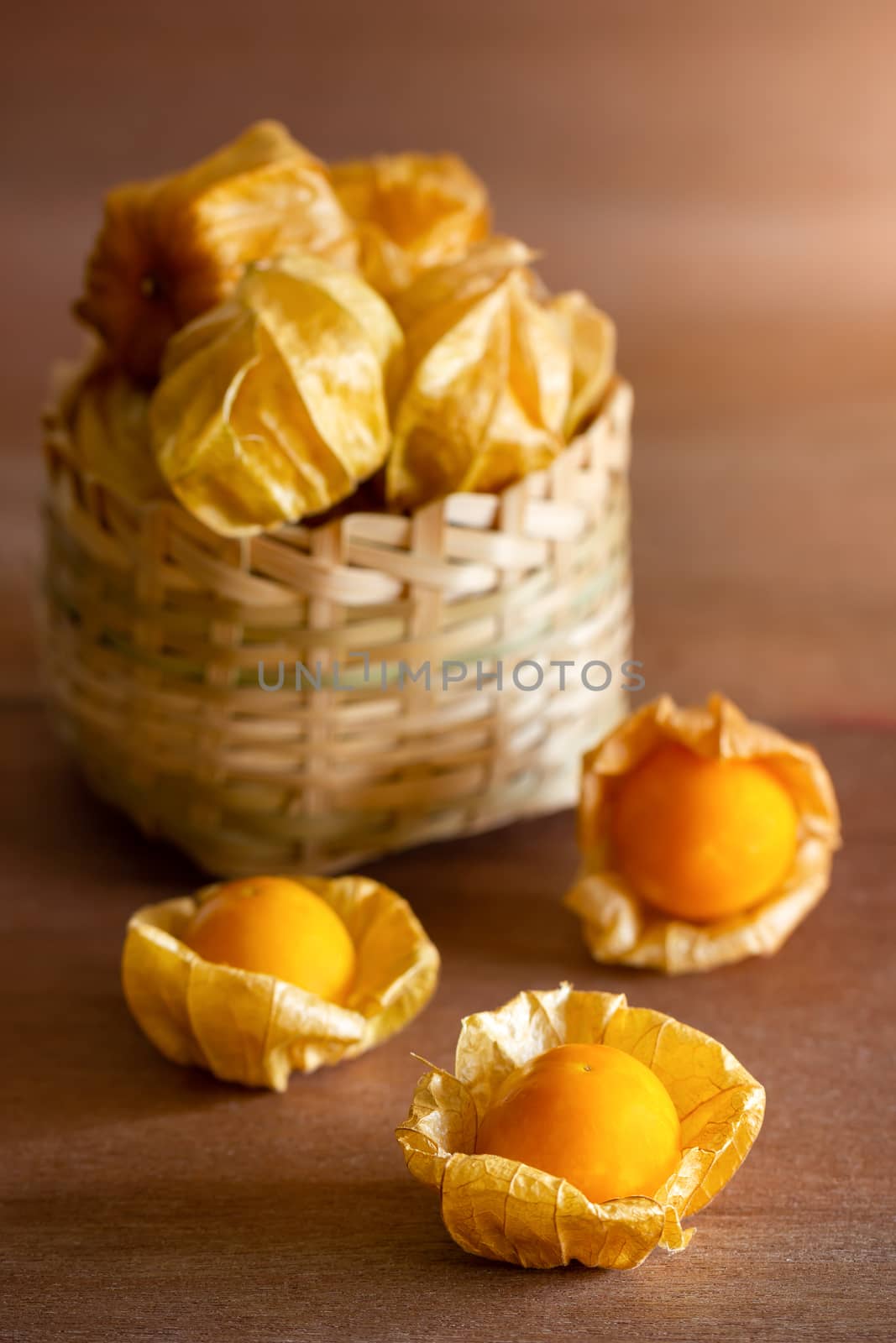 Cape gooseberry in bamboo basket. Concept of health care or herb. Closeup and copy space for text.