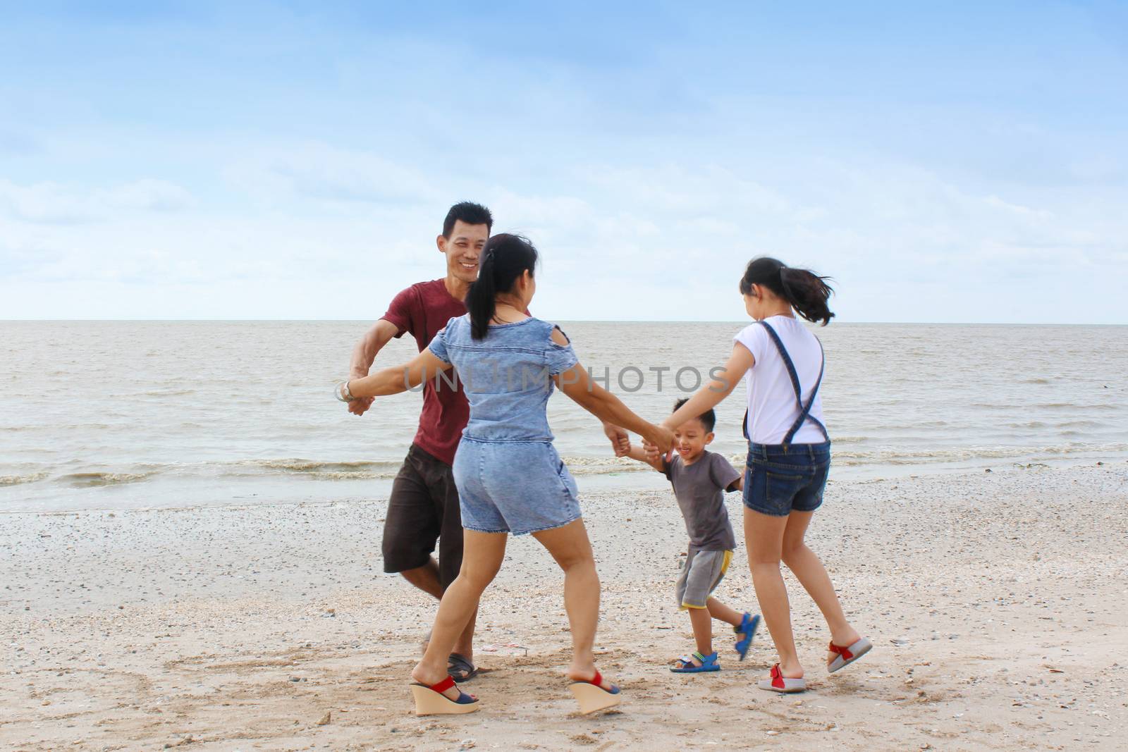 happy asian family having fun on beach.