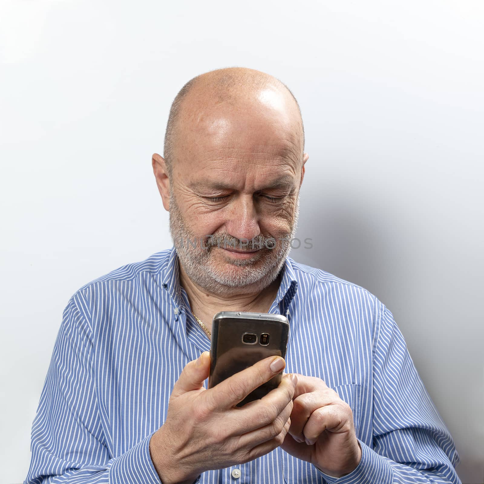 A middle aged man with cell phone by sergiodv