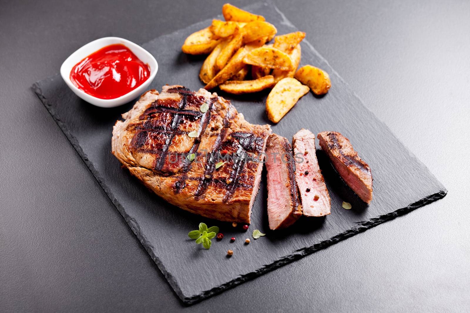 Platter Of Grilled Steak With Potatoes And Ketchup by mpessaris