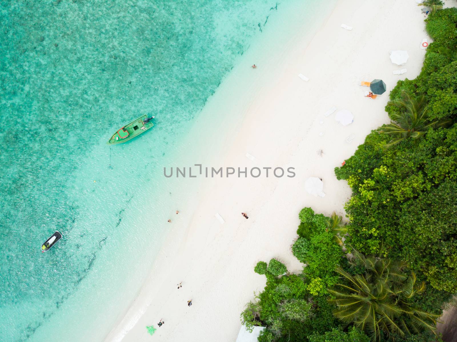 Aerial drone view of picture perfect beach and turquoise lagoon on small tropical island on Maldives.
