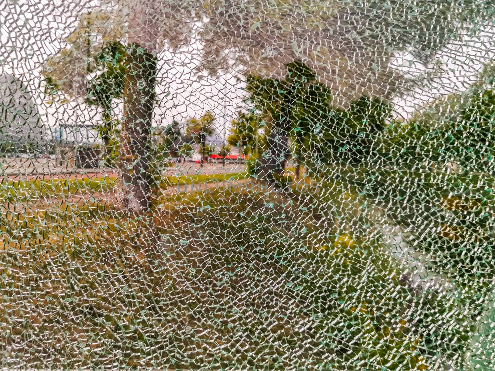 glass window completely cracked, scenery shining through, Shattered fragments, Abstract background by charlottebleijenberg