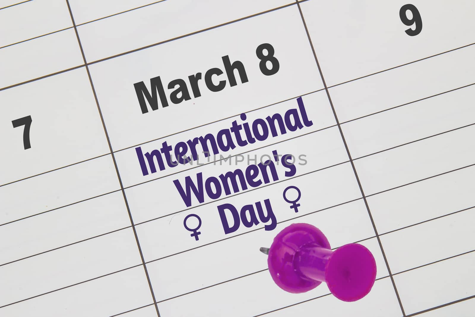 A close up to a Calendar on March 8 with the text: International Women's Day with a pink and woman's symbols.