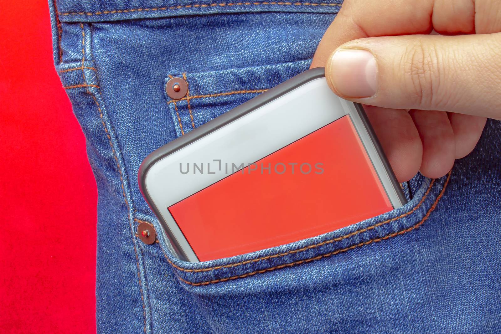 A person putting on a pocket a smart phone with a red screen