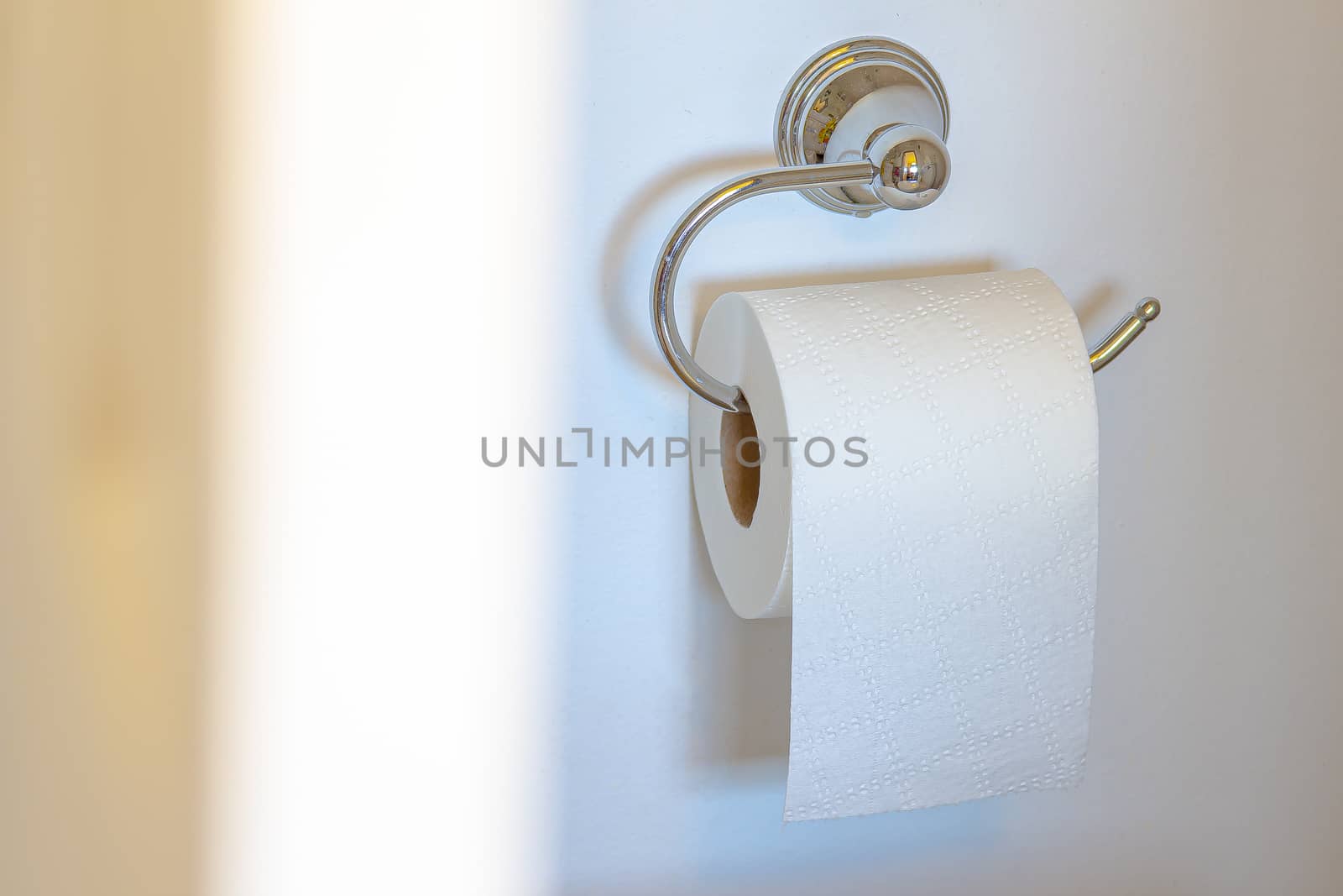 Single Post Toilet Paper Holder on a white wall background with soft shadow and defucus door by oasisamuel
