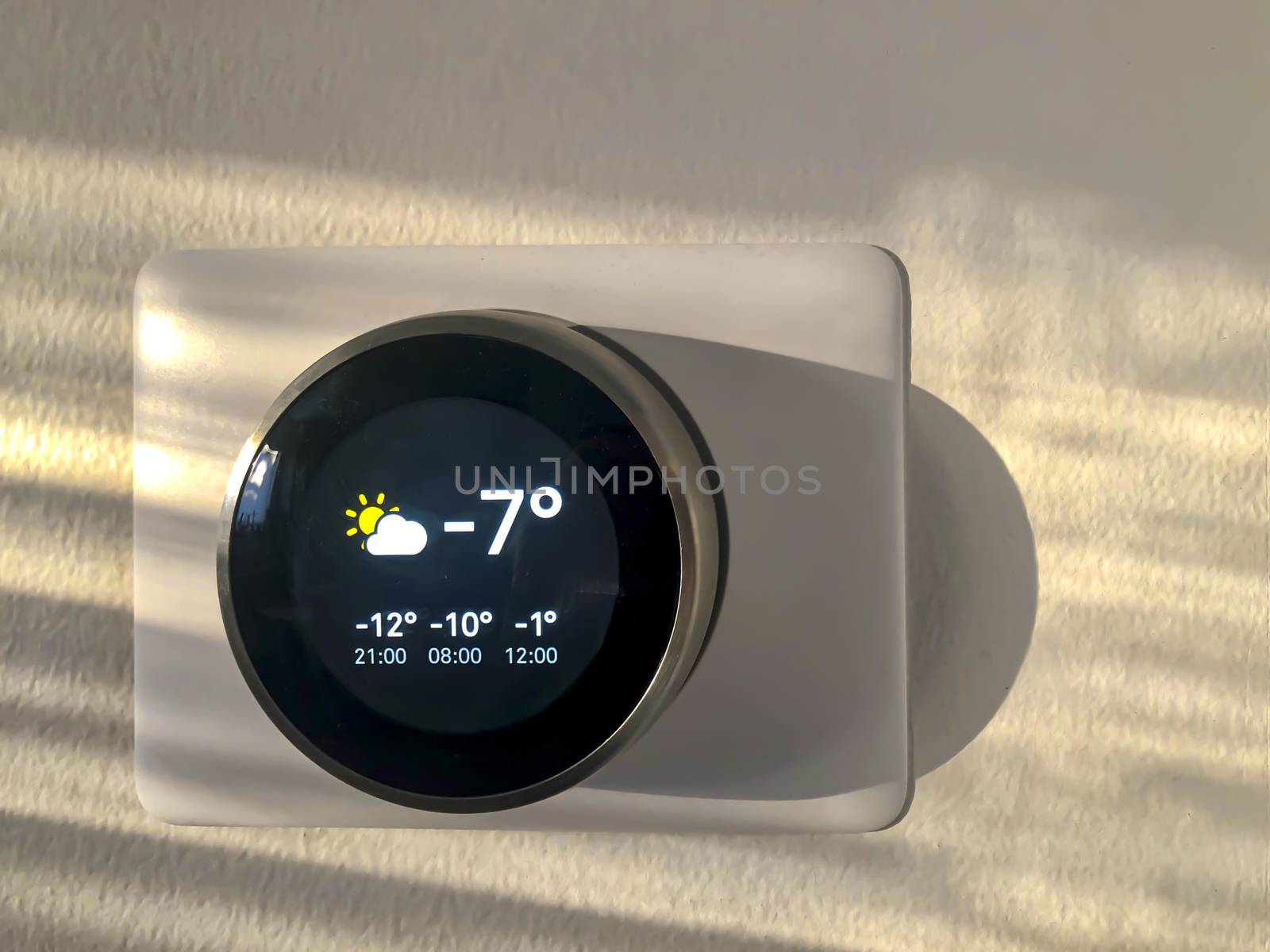 Smart Thermostat with the outside temperature during winter during the afternoon sunset