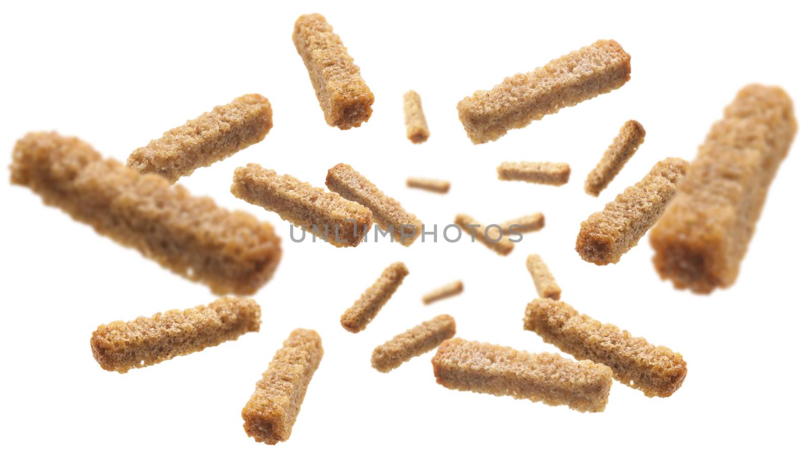 Bread croutons levitate on a white background.