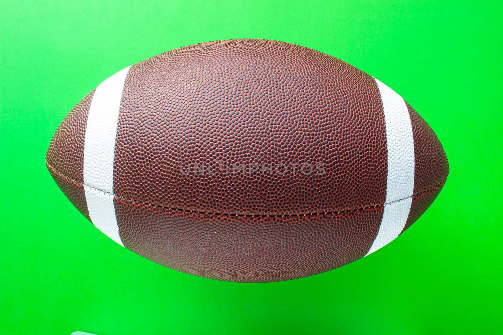 A football on a green background by oasisamuel