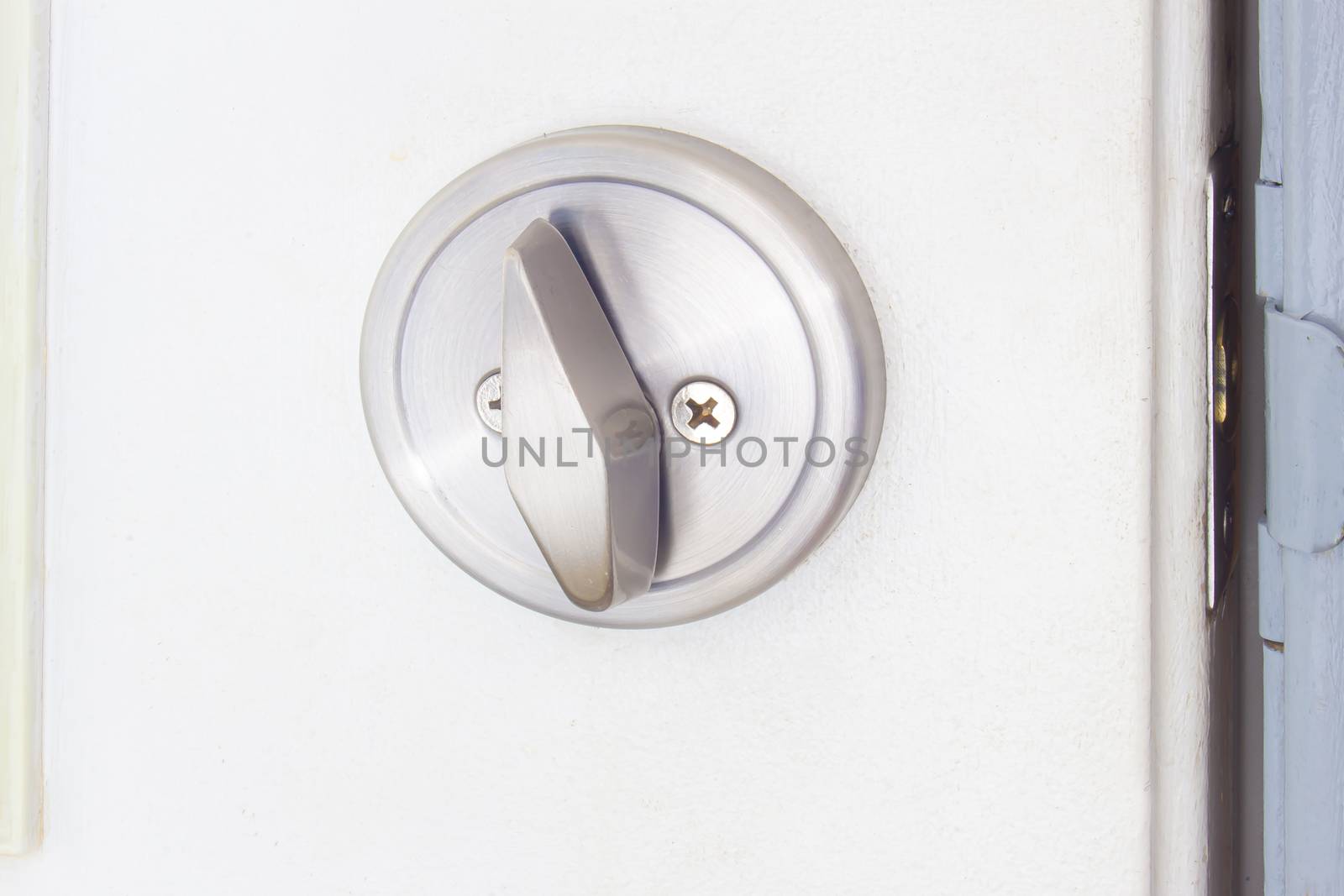 Open round pocket door lock on a white door