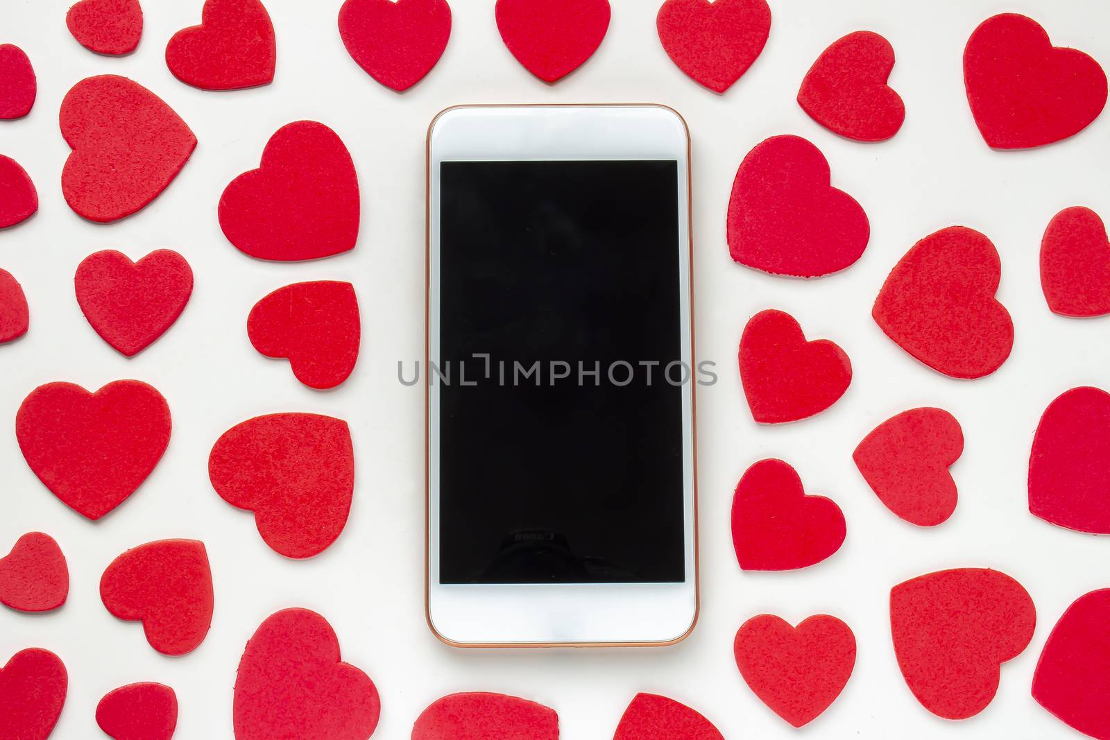 A smart phone with red hearts around on a white background by oasisamuel