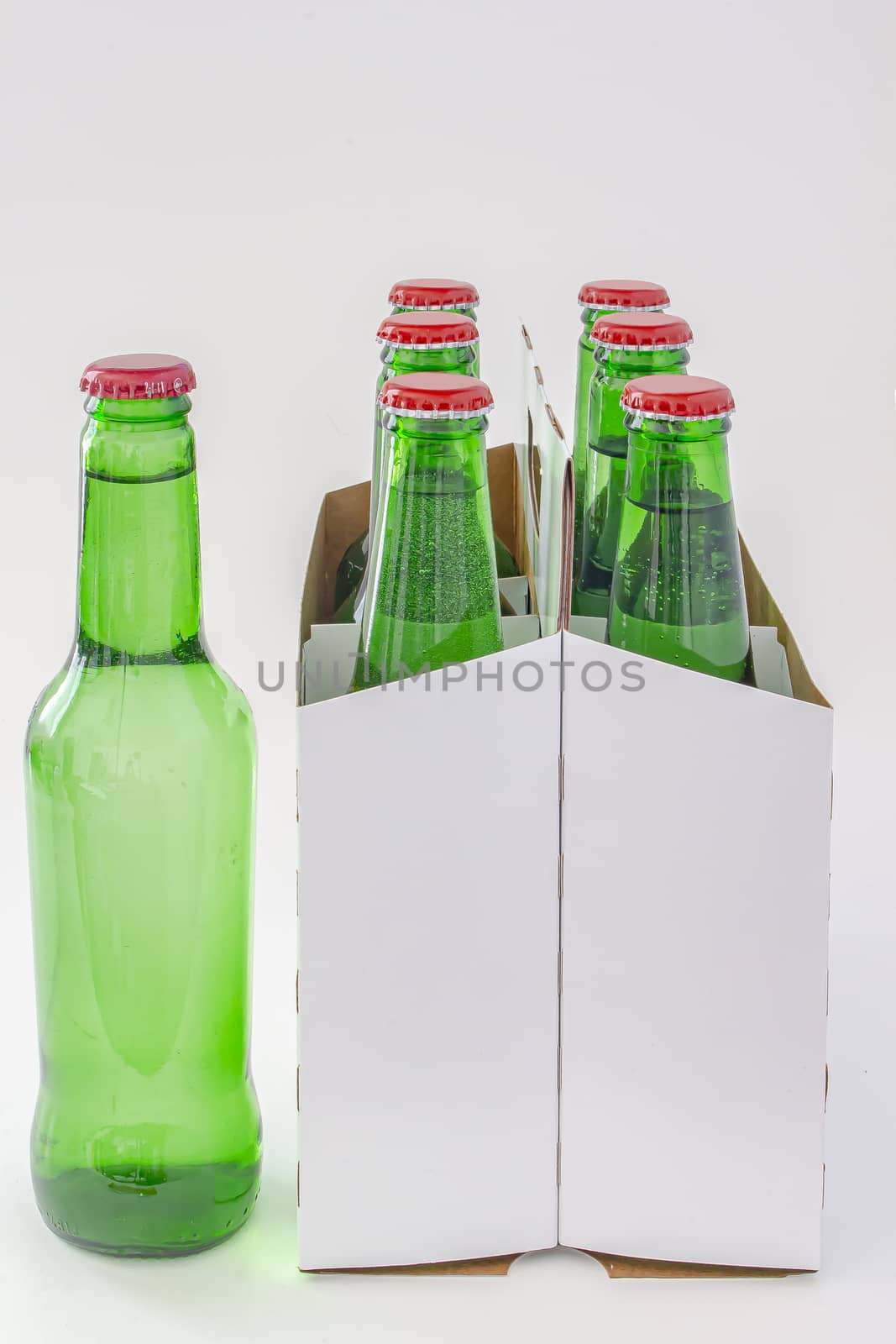 A six pack of a green beer bottles isolated on white background by oasisamuel