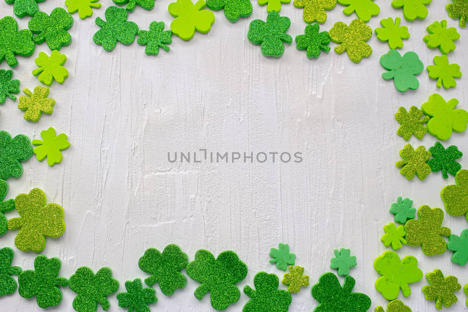 Green clovers with a white textured background