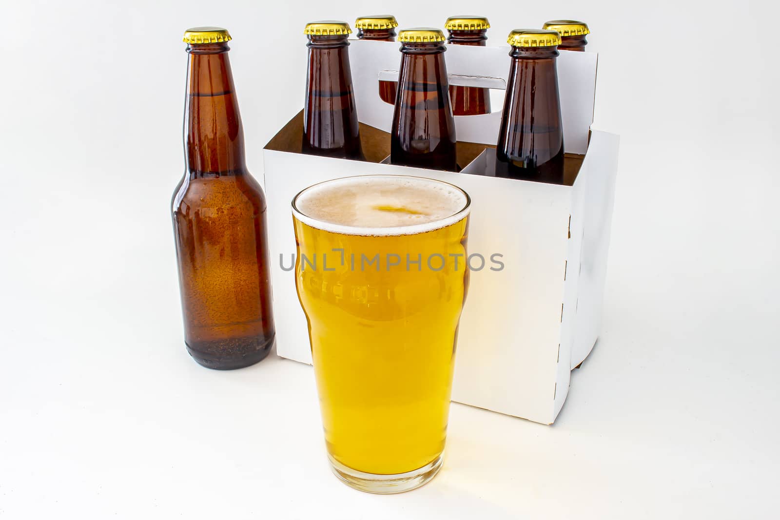a Pilsner Style Lager brown bottle sic pack with a full pint of beer