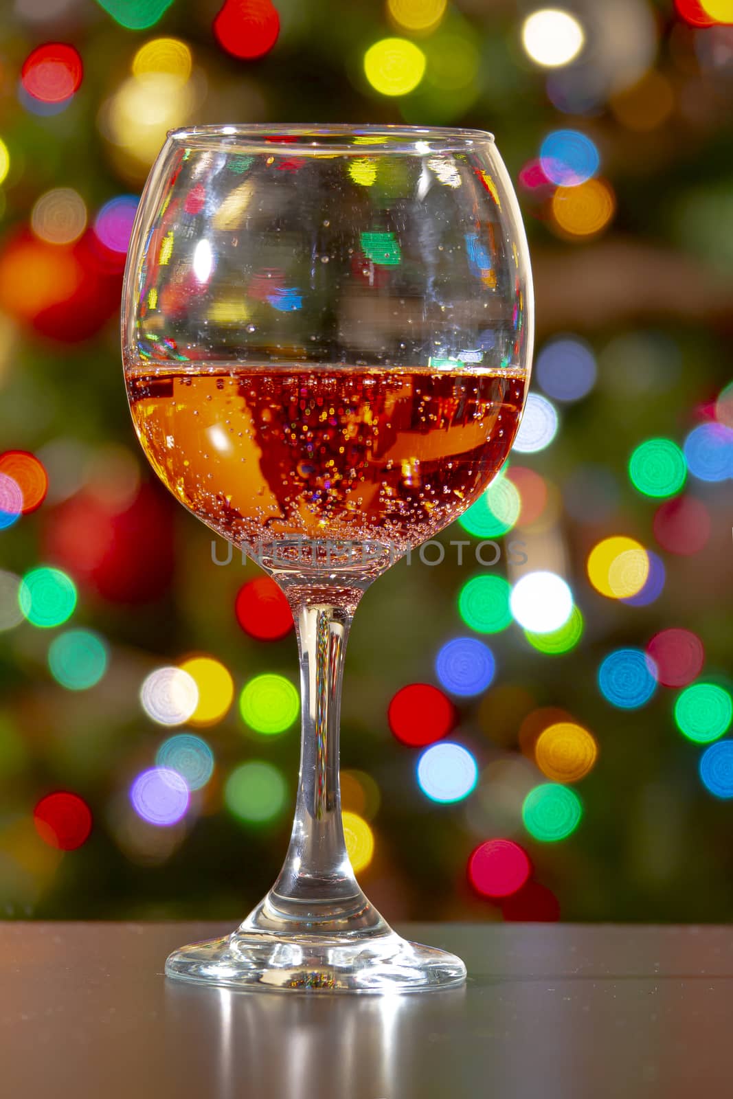 Sweet Fruity Sparkling Rose Wine with bubbles on a wine cup with colourful lights