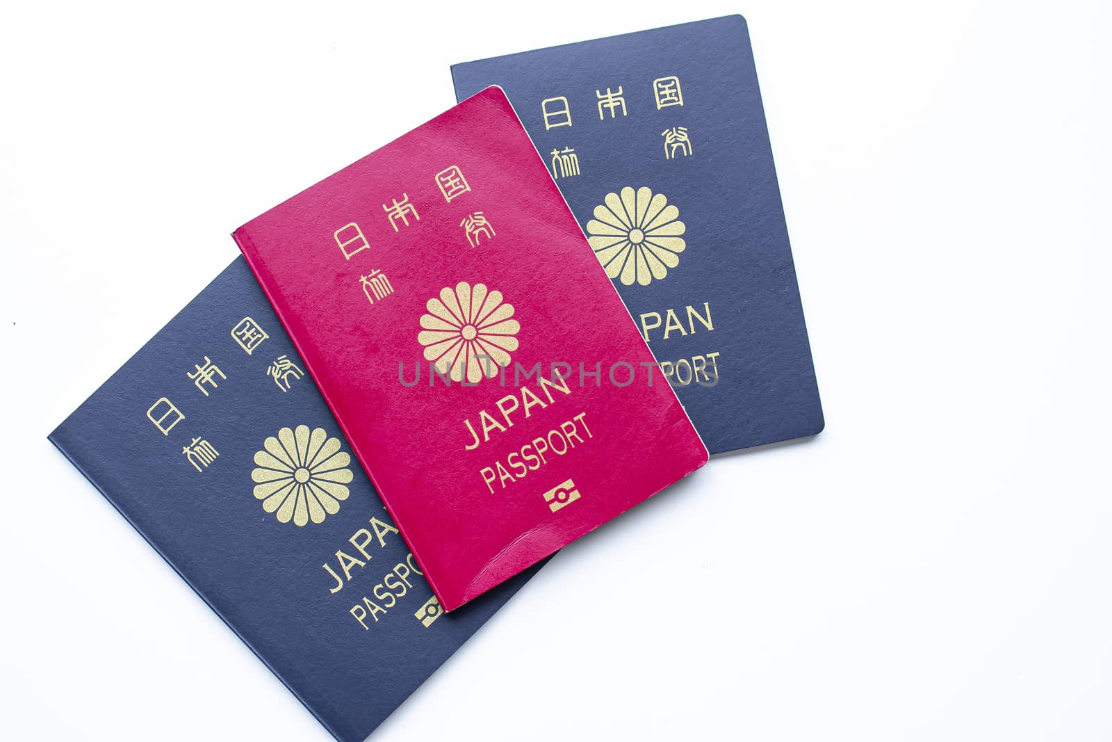 Japanese red and dark passports on a white background