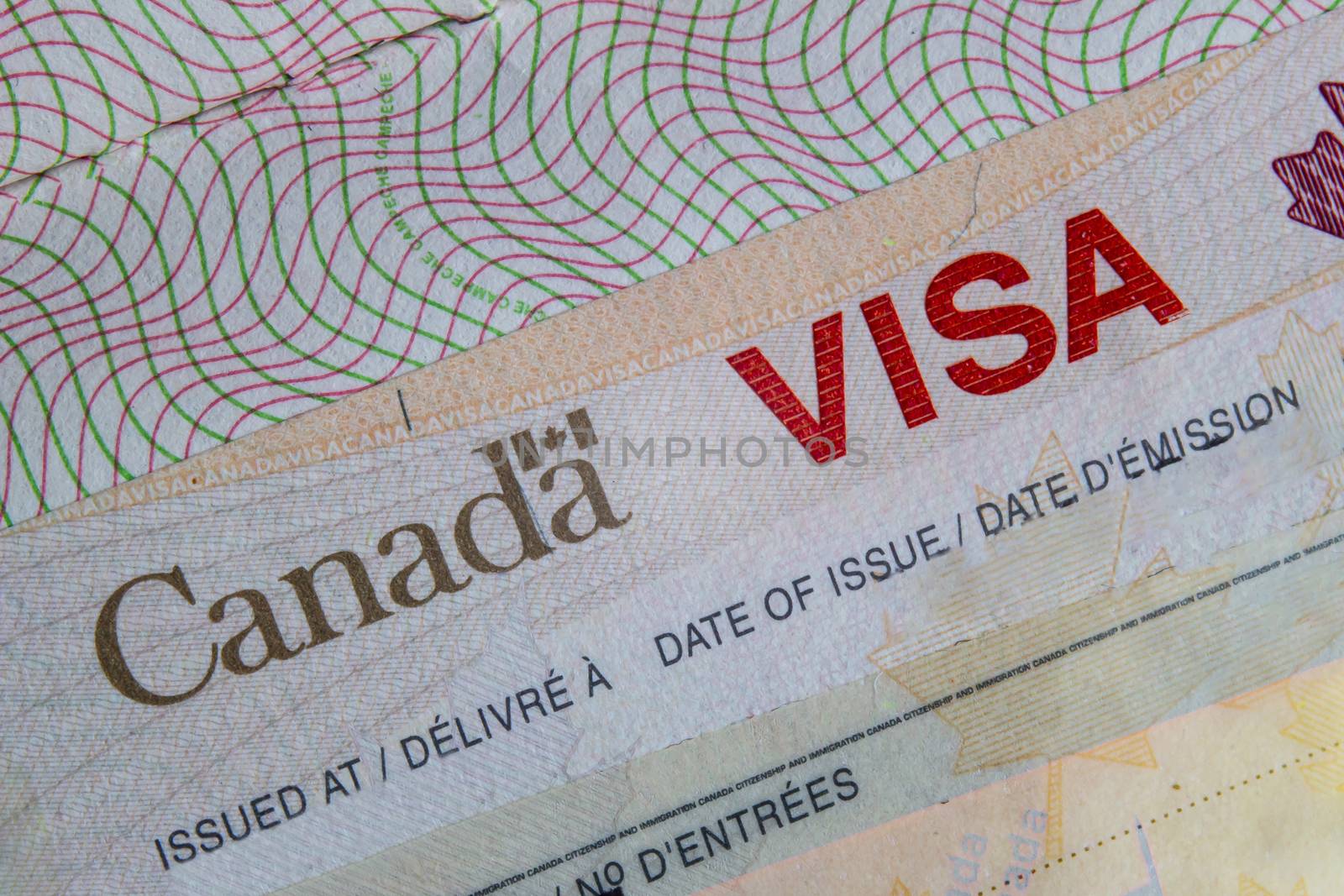 A Close up of a Canada VISA on a passport inside page by oasisamuel