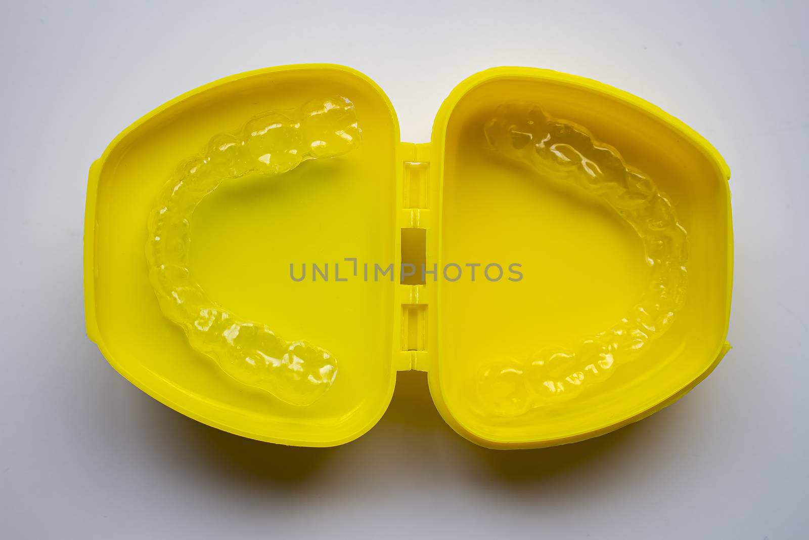 Mouth Guard on a yellow case with a white background by oasisamuel