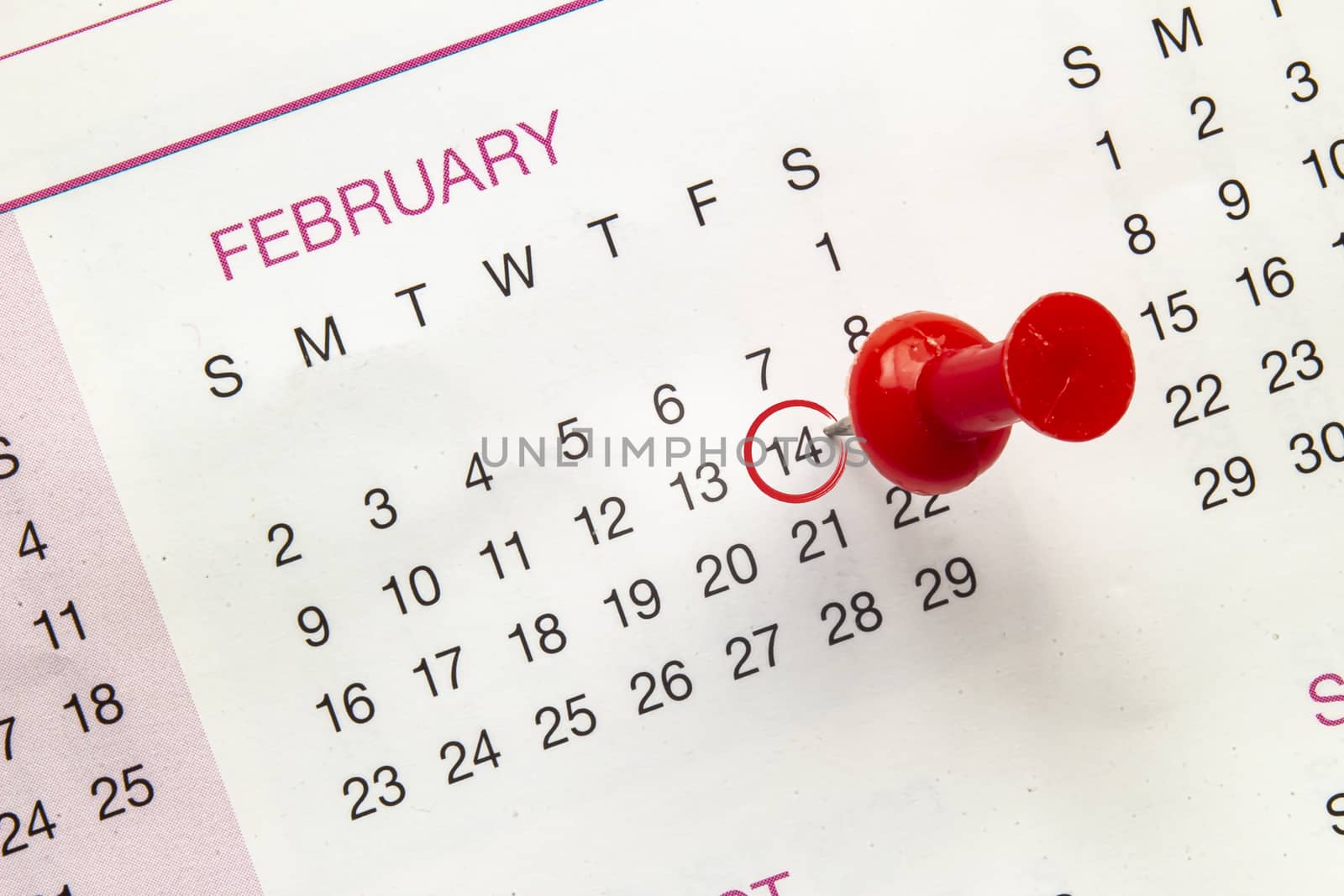 A close up to a calendar on February 14 with a pin and a red circle