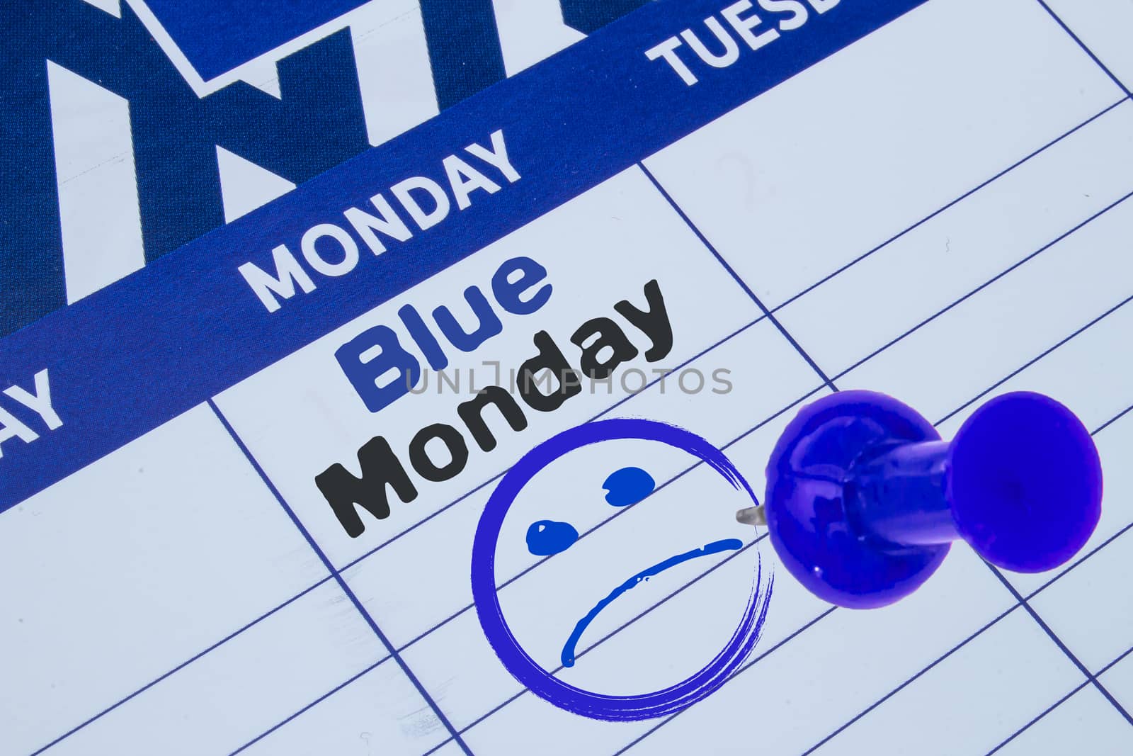 A close up on a calendar on the Blue Monday on blue black text with a Sad face and blue pin by oasisamuel