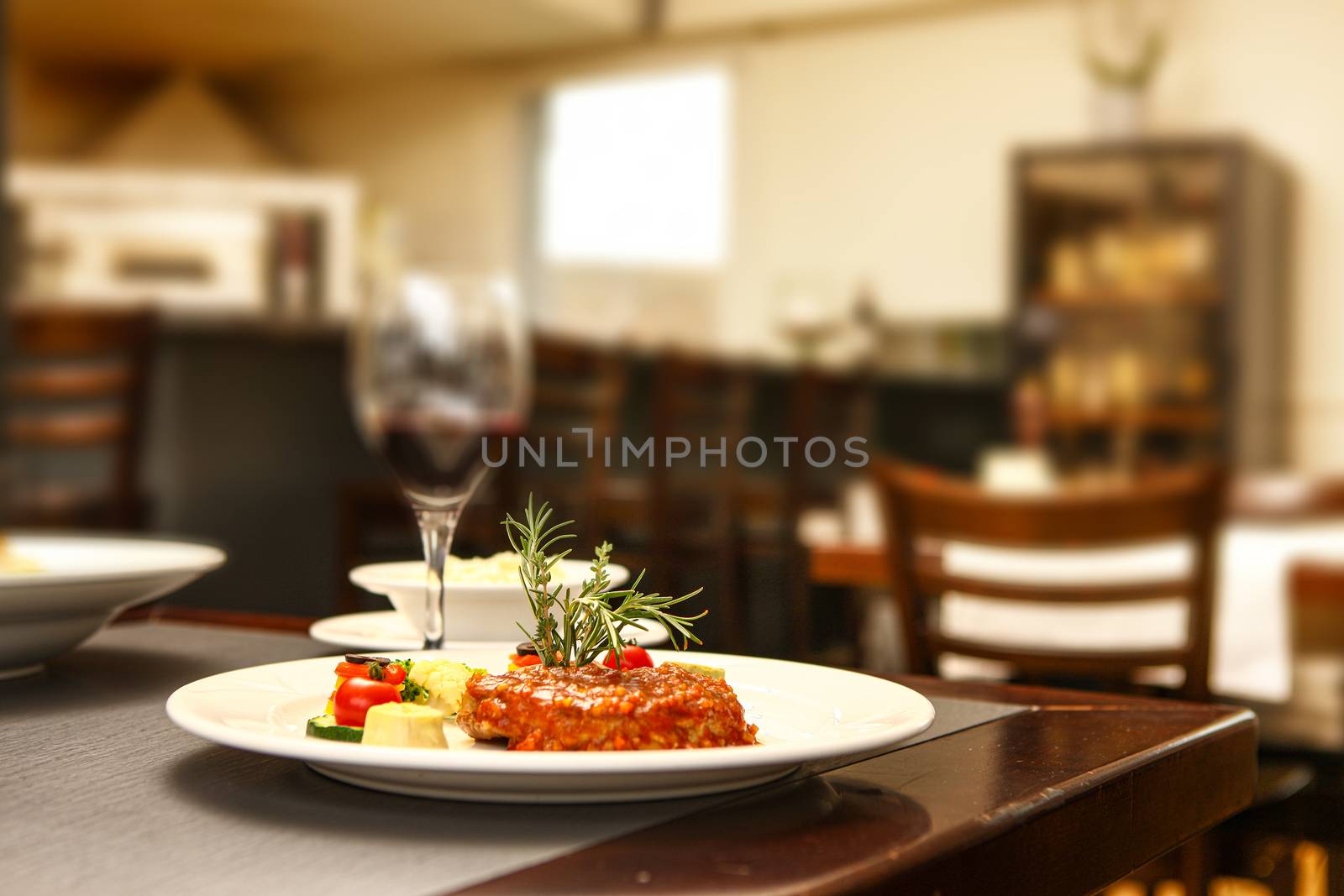 steak with tomato and pepper mit in background