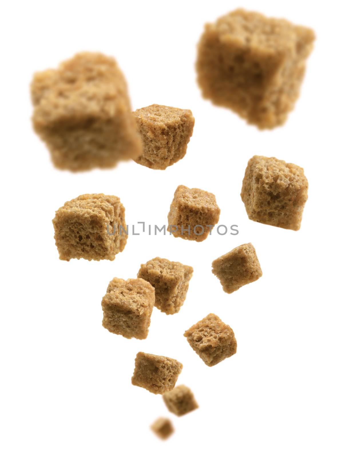 Bread croutons levitate on a white background.