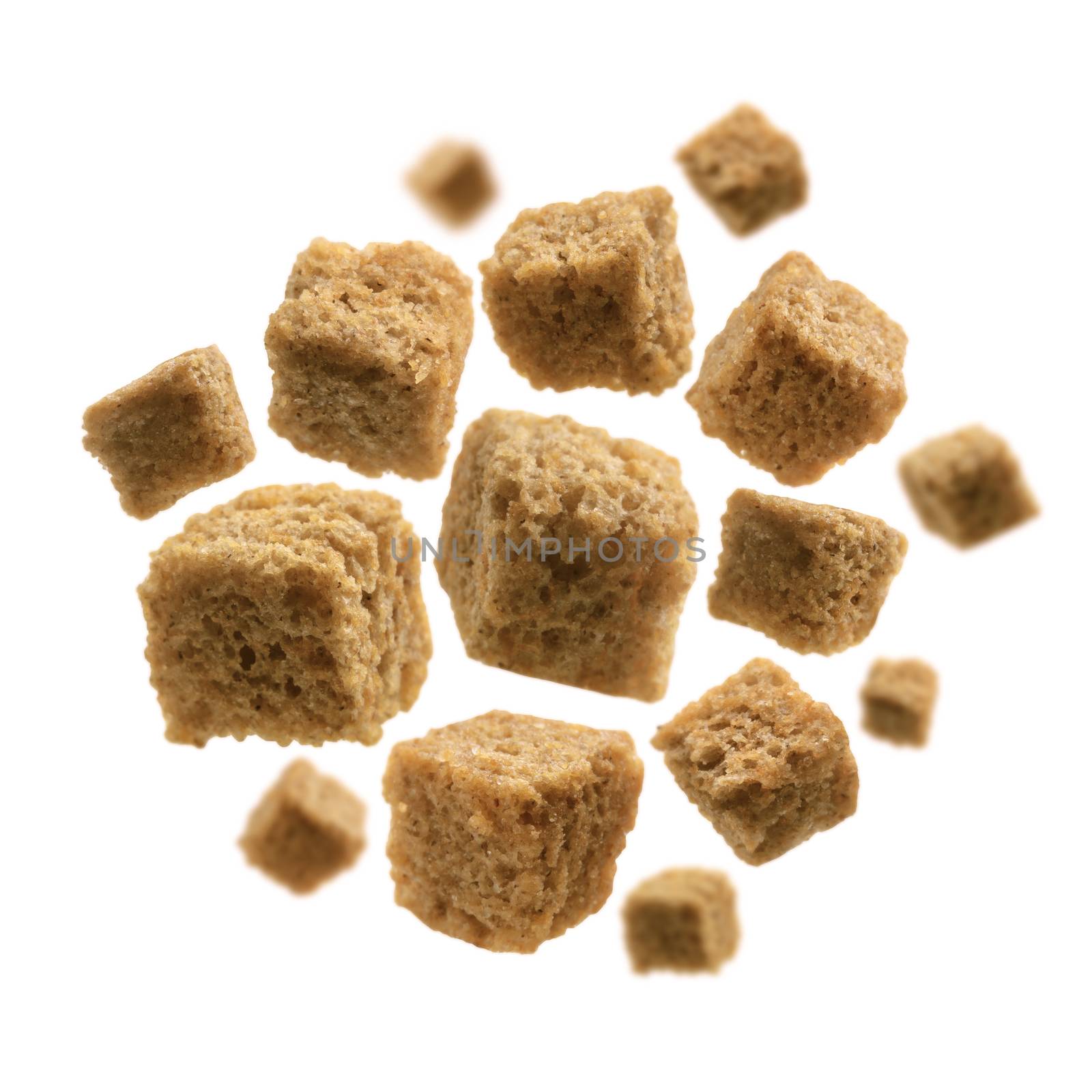 Bread croutons levitate on a white background.